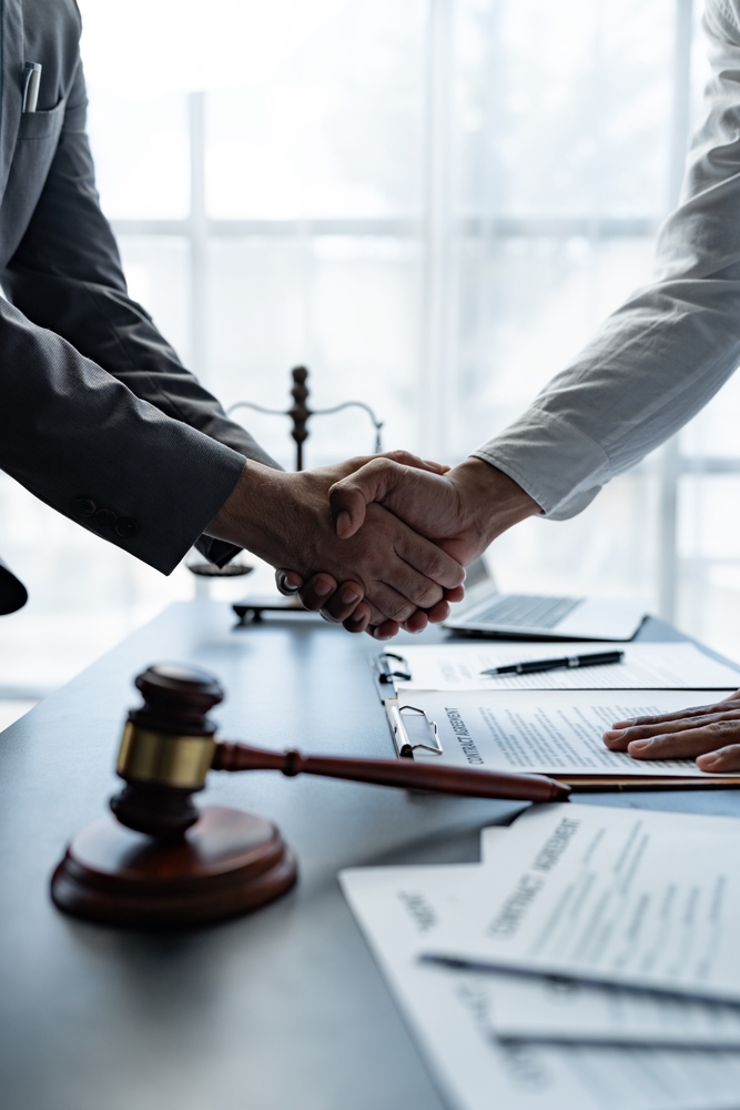 Handshake representing successful cooperation between attorney and consulting client
