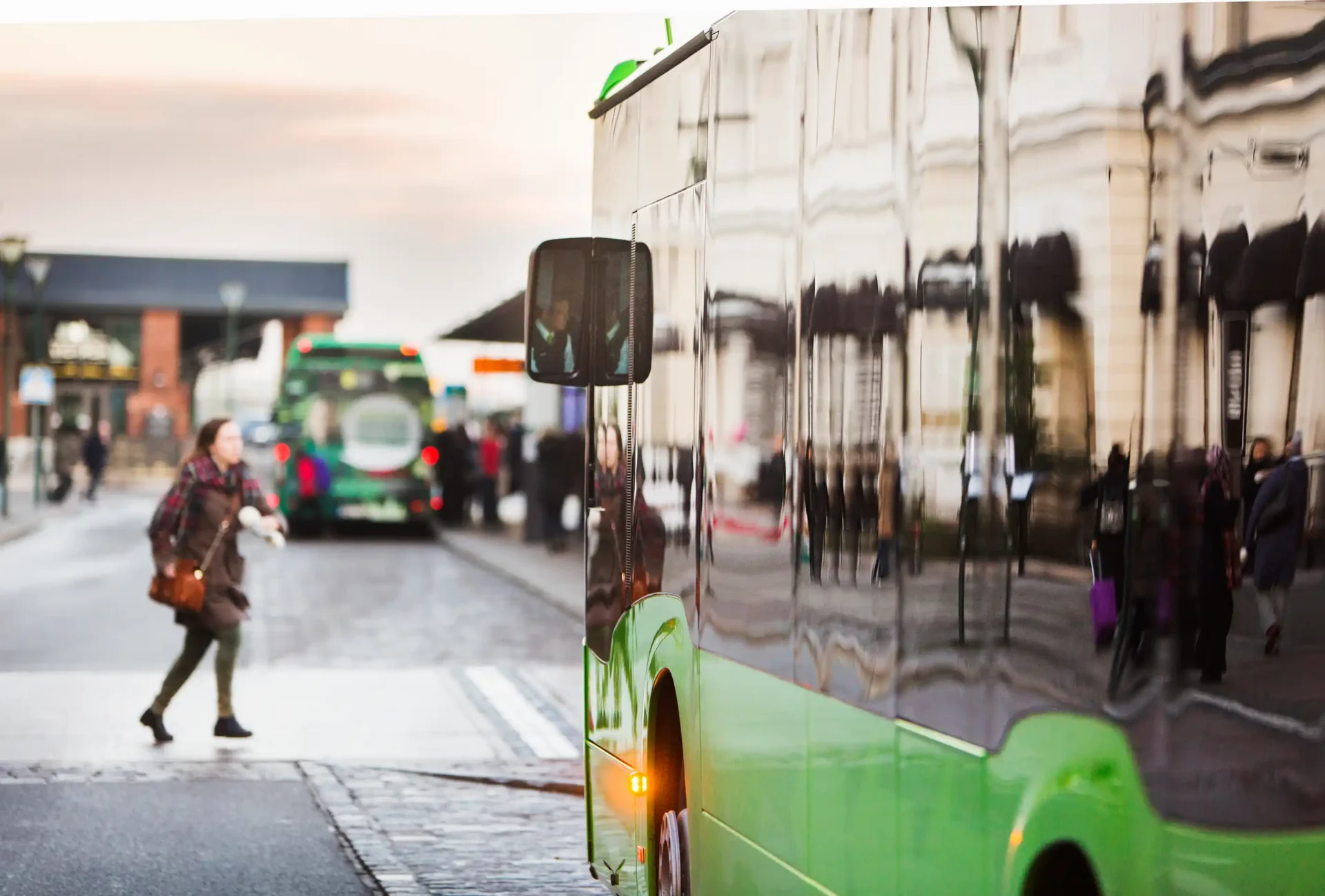 bus on a busy street with pedestrians walking around